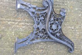 Pair of black painted metal bench ends with pierced design,