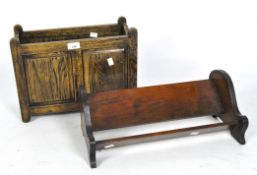 An early 20th century farmhouse style oak magazine rack and a mahogany bookshelf,