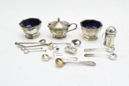 A collection of 19th & 20th century silver, including a condiment set, spoons, charms and more,