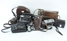 A collection of vintage cameras and binoculars