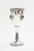 A white metal cup set with three malachite cabochons