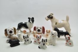 A collection of ceramic models of dogs, including Staffordshire pottery spaniels,