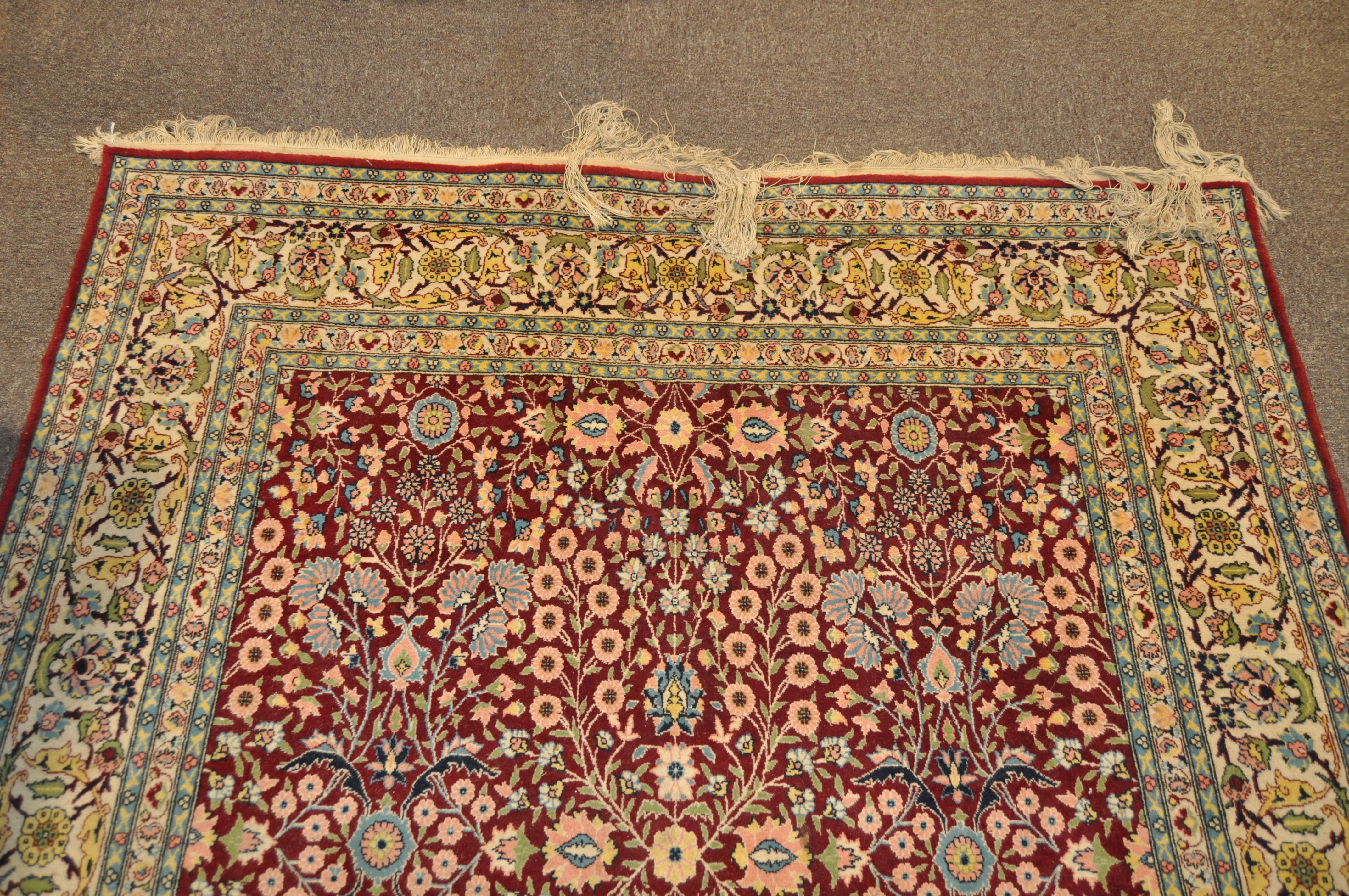 A 20th century Turkish rug, woven with dense flowers on a dark red ground, - Image 5 of 7