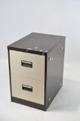 A two drawer metal filing cabinet in brown and beige,