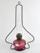 A 20th century cranberry glass oil lamp,