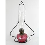 A 20th century cranberry glass oil lamp,