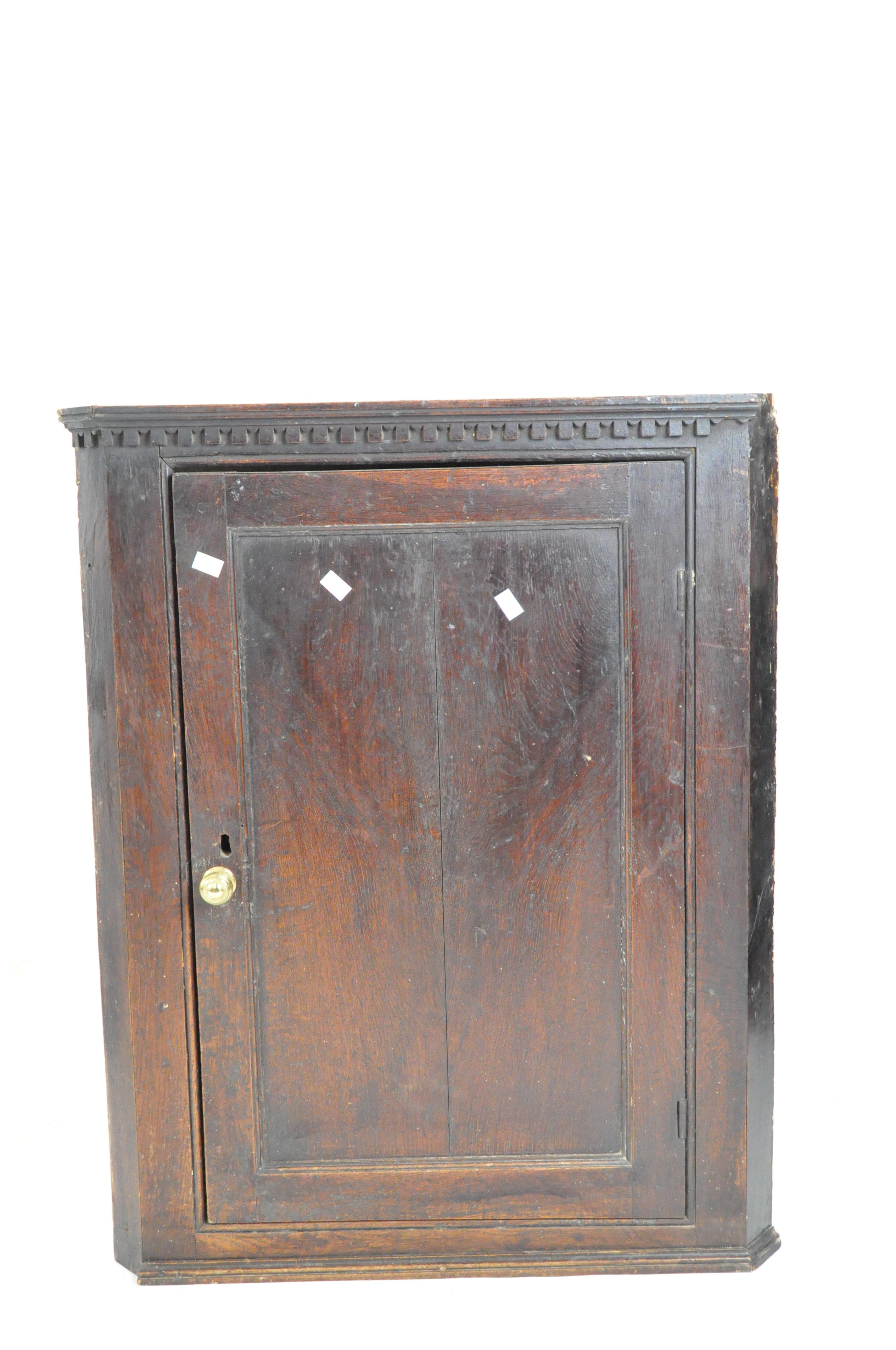 A Georgian oak corner cupboard,