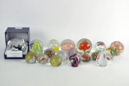 A collection of assorted glass paperweights, to include one by Caithness 'Ribbons'