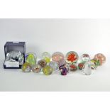 A collection of assorted glass paperweights, to include one by Caithness 'Ribbons'