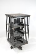 An early 20th century large black revolving bookcase,