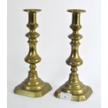 A pair of late 19th century brass candlesticks,