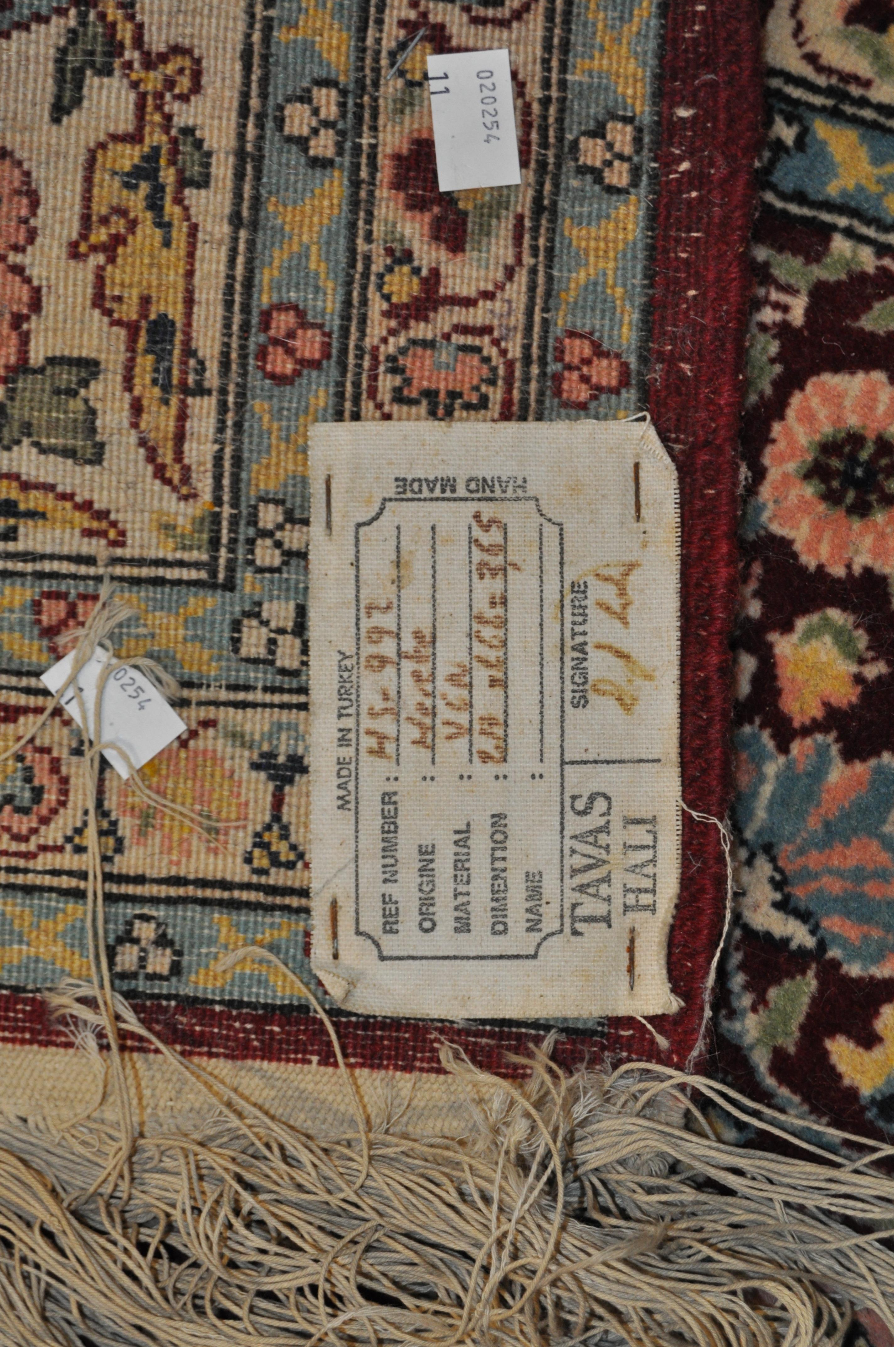 A 20th century Turkish rug, woven with dense flowers on a dark red ground, - Image 2 of 7