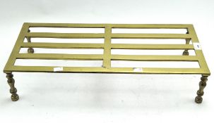 A brass trivet stand of rectangular form,