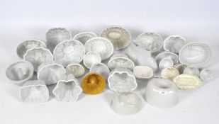 A collection of Staffordshire pottery white glazed jelly moulds in assorted shapes,