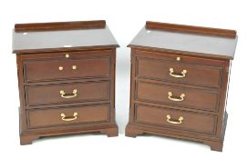 A pair of contemporary bedside chests of drawers, each comprising three drawers,