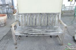 An early 20th century wooden slatted garden bench,