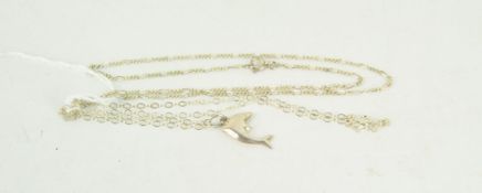 Two contemporary silver chain necklaces, one with a dolphin pendant,