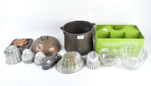 An assortment of metal and glassware, comprising mostly jelly moulds and cake moulds,