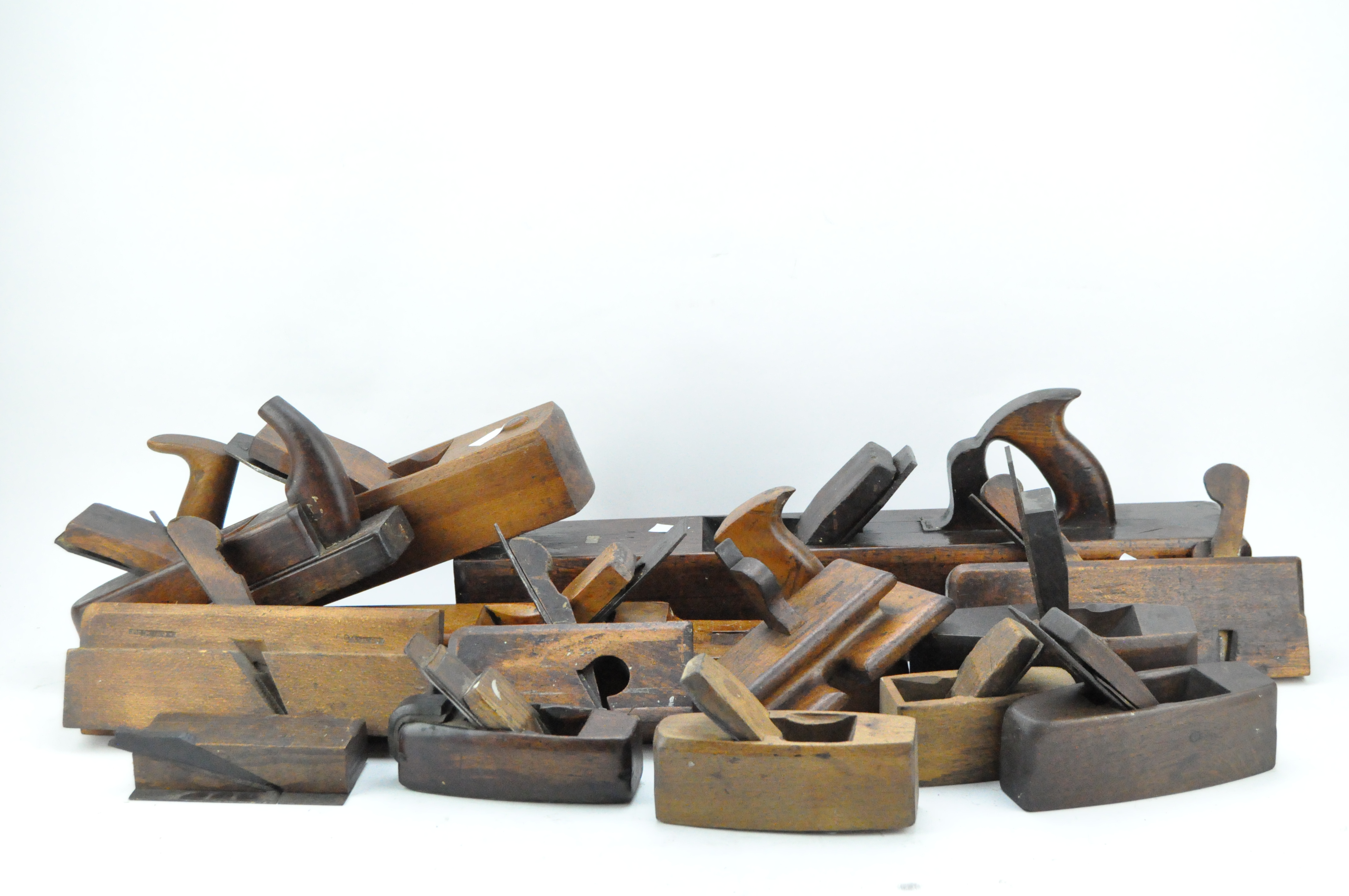 A collection of approximately 20 vintage wooden planes,