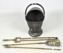 A Victorian copper coal scuttle and a brass fire companion set,