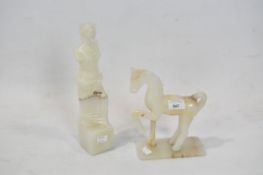 Two contemporary onyx sculptures, one featuring a nude figure, the other a horse,