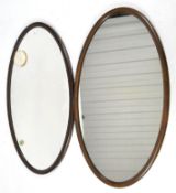 Two large oval wall mirrors, one being Victorian