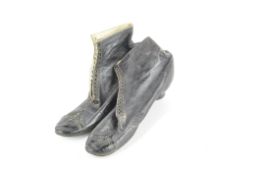 A pair of early small black leather boots.