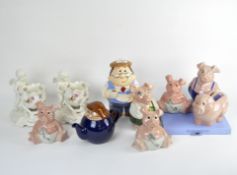 A group of five Wade Natwest pig money banks and other ceramics, including a Wade Tetley teapot,