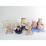 A group of five Wade Natwest pig money banks and other ceramics, including a Wade Tetley teapot,