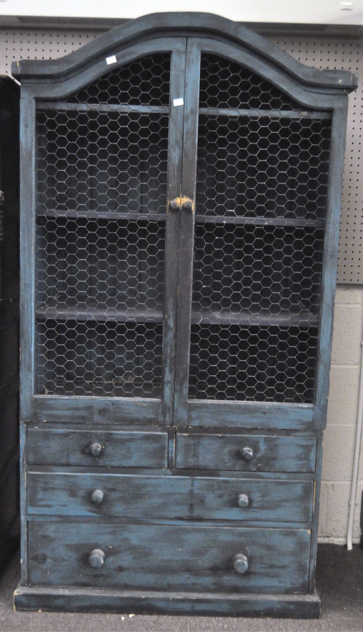 A vintage blue painted pine kitchen cabinet, the two door cupboard with chicken wire covers,