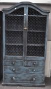 A vintage blue painted pine kitchen cabinet, the two door cupboard with chicken wire covers,