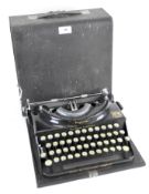 A vintage Imperial typewriter, in black with gilt details and the Royal crest,