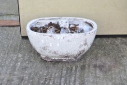 A crackle glazed ceramic plant pot of oval form,