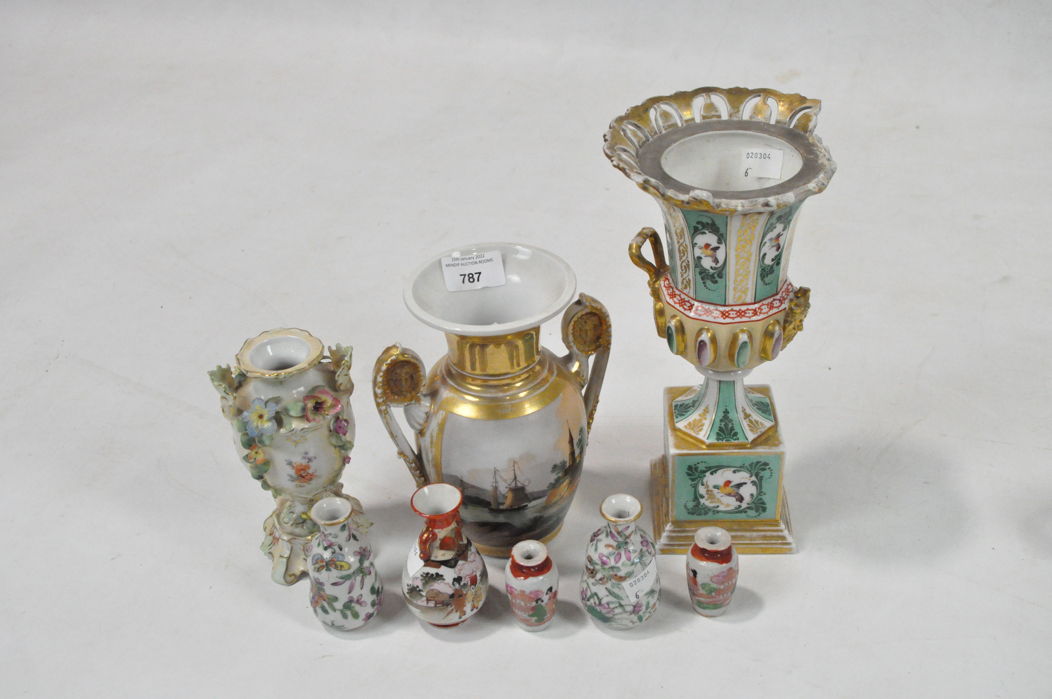 A group of porcelain vases including a gilt two-handled example painted with two landscape scenes,