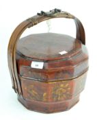 A vintage Chinese rice basket, in red lacquer and decorated with flowers,