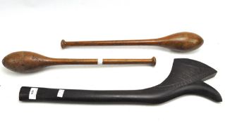 An unusual tribal carved wooden throwing club and two wooden exercise clubs