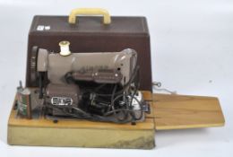 A vintage Singer sewing machine and accessories