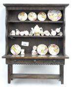 An oak miniature kitchen dresser and a Carmarthen bone china miniature part tea service,