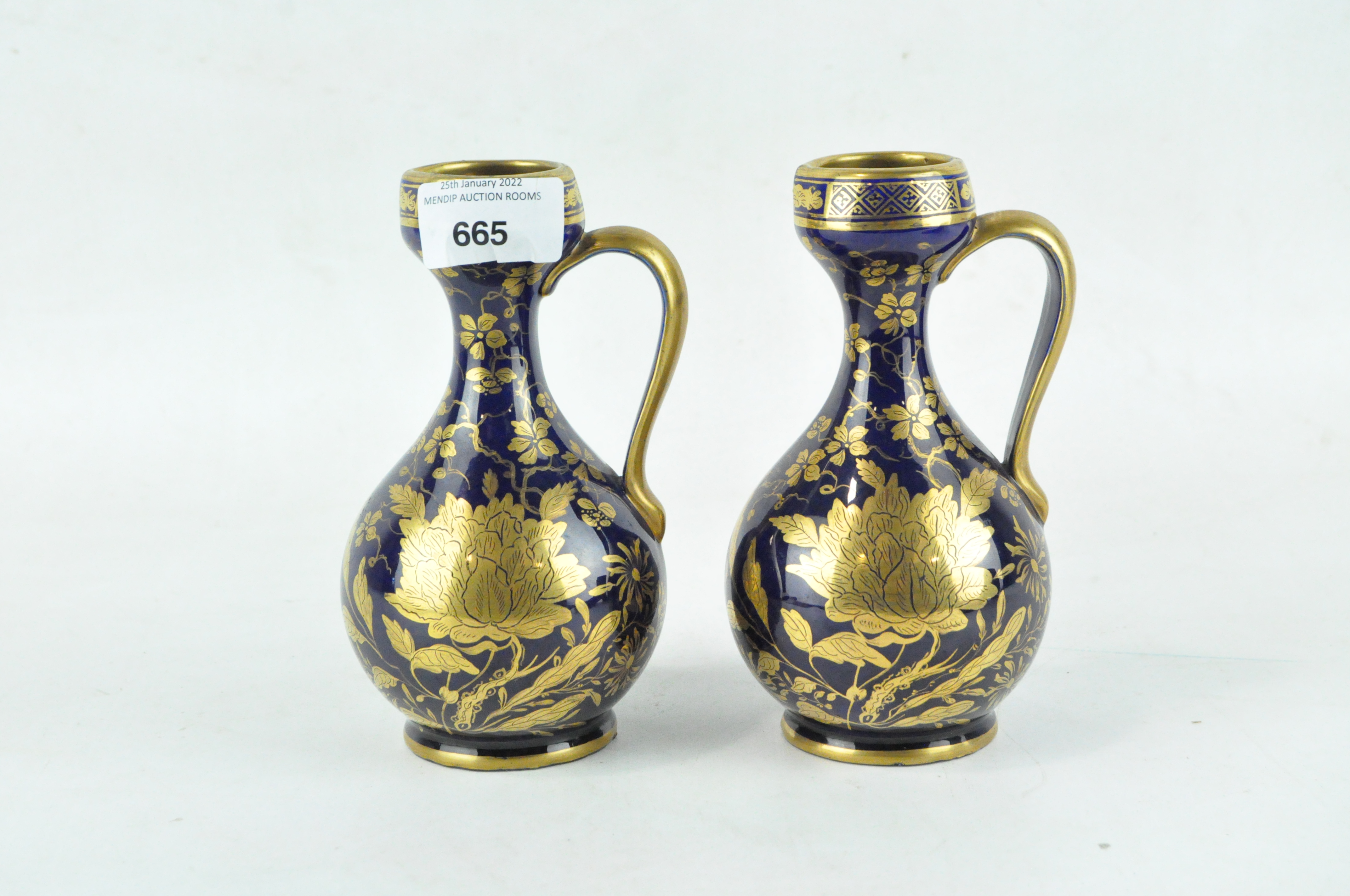 A pair of 19th century Staffordshire glazed ceramic ewers,