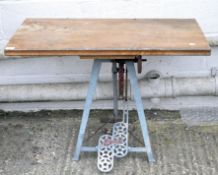 An early 20th century low work table with wooden top,