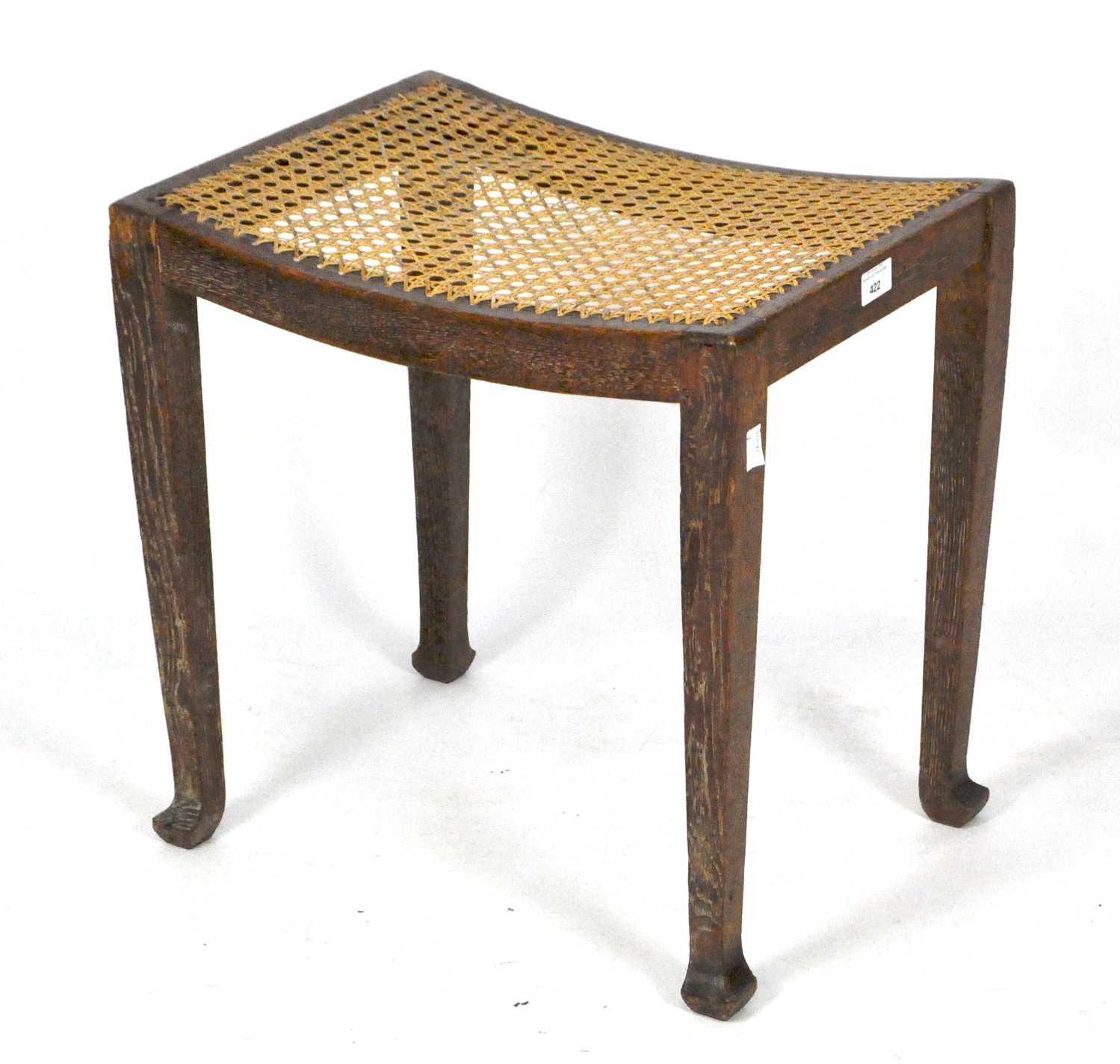 A vintage limed oak stool by the Bowman brothers, with attached label to base and caned seat,