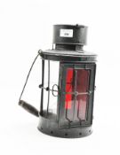 A 20th century black painted metal railway lantern of cylindrical form,