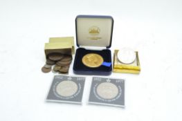 An assortment of loose coins, the selection covering a variety of locations and eras,