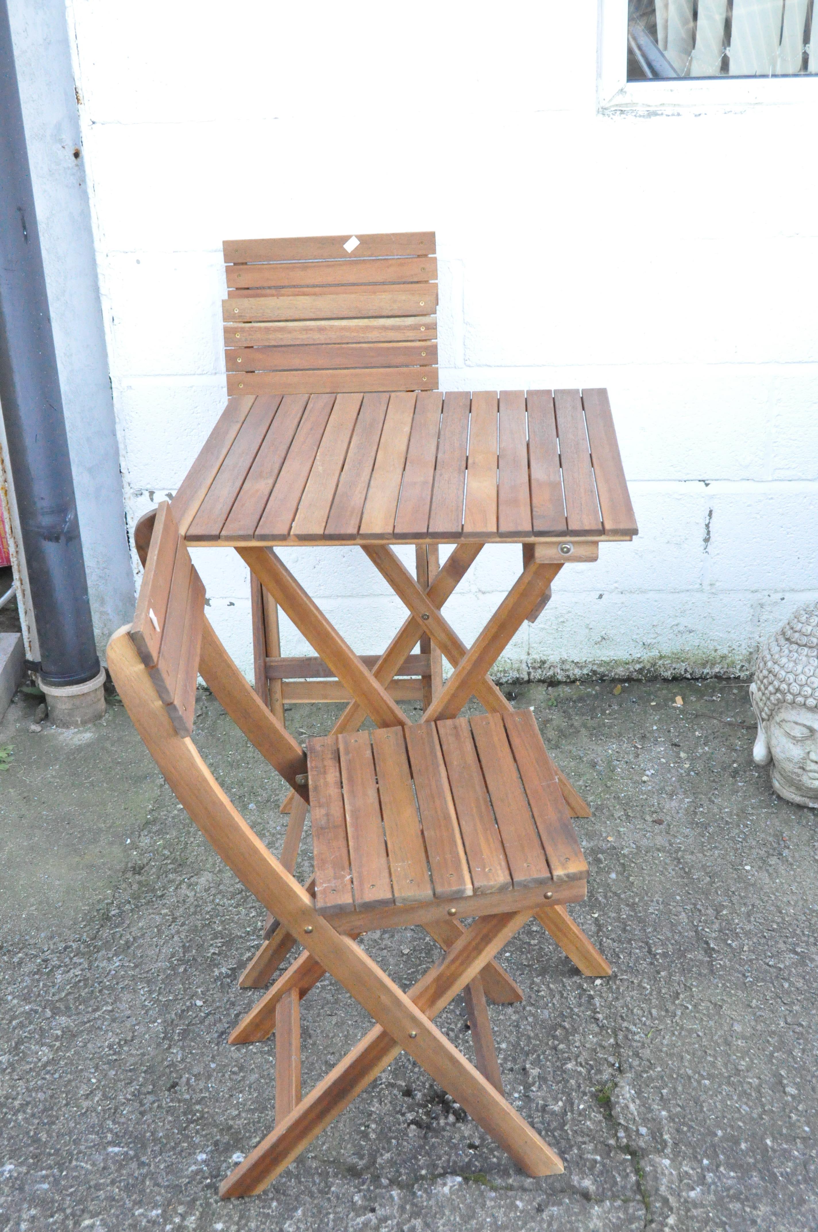 A modern folding wooden patio table and a pair of matching chairs,