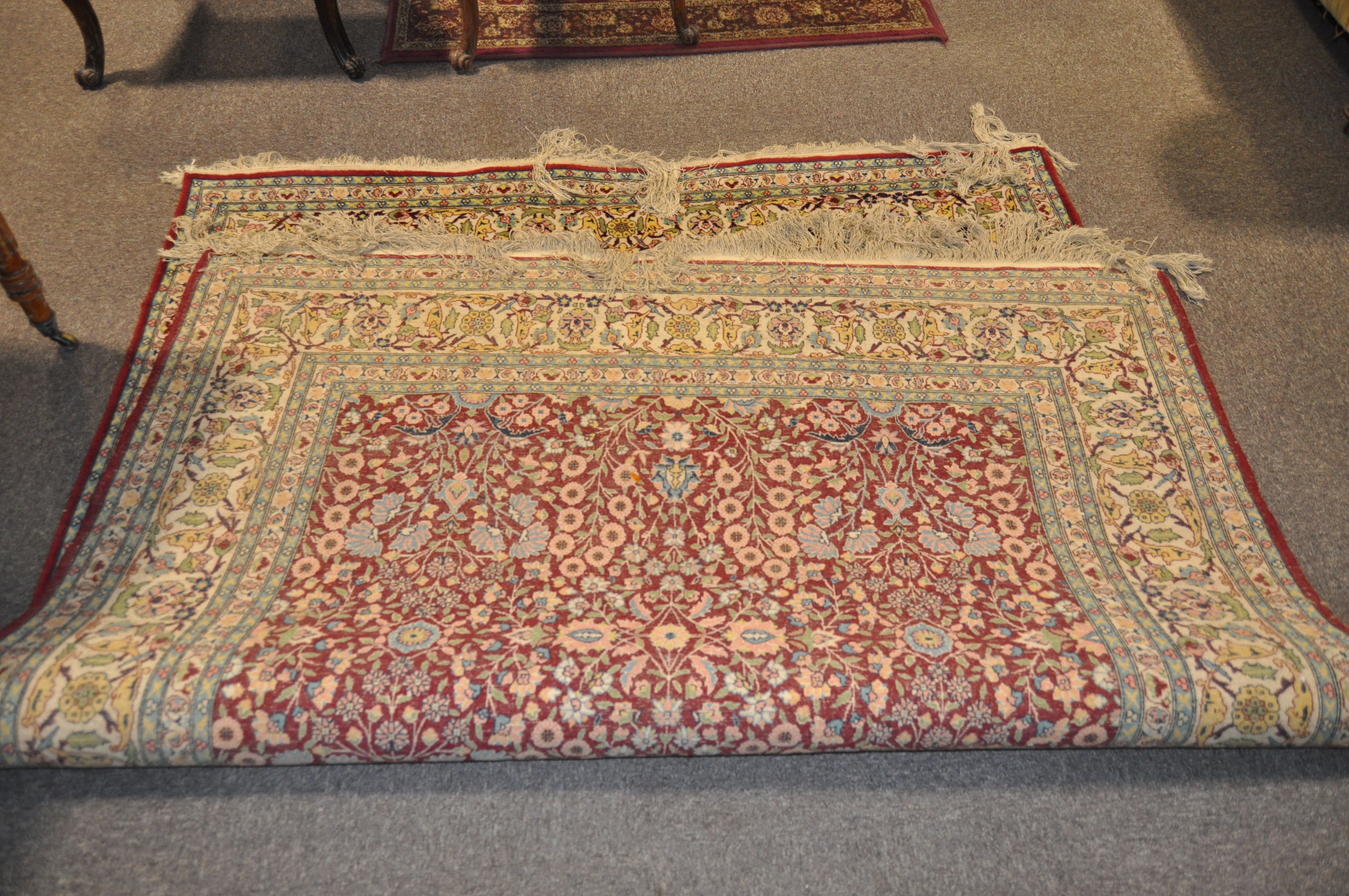 A 20th century Turkish rug, woven with dense flowers on a dark red ground, - Image 4 of 7