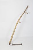 A scythe with two turned handles,