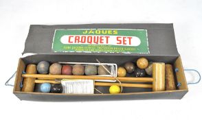 A Jaques croquet set, containing balls and mallets, in the original box, length of box 106.