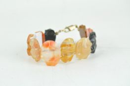 An Agate and hard stone bracelet on a 9ct gold clasp