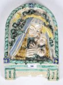 An Italian Majolica arched rectangular wall plaque of Madonna and child,
