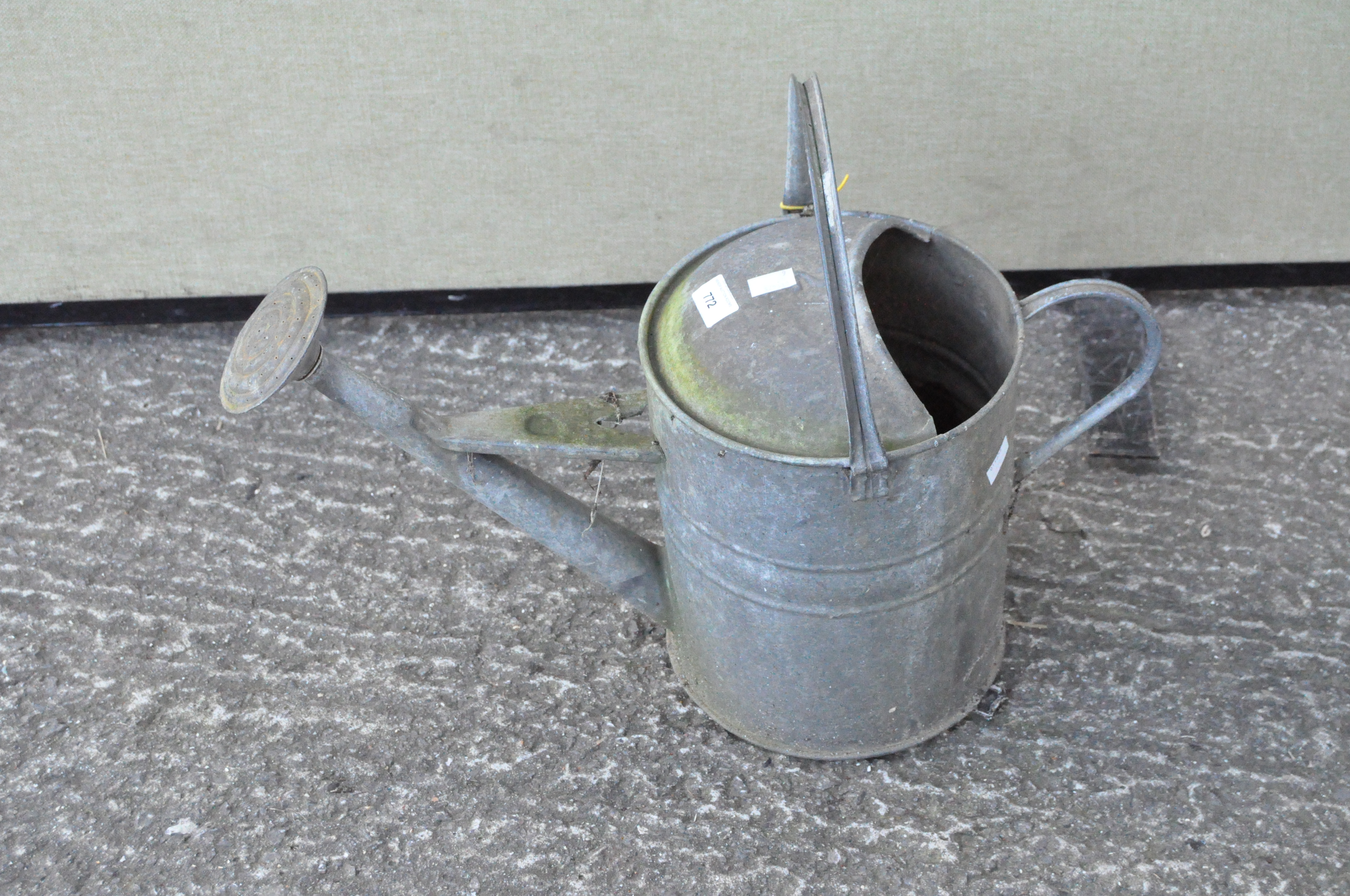 A galvanised watering can,
